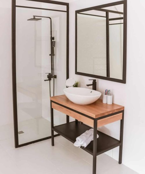 White modern shower room with glass partition and washbasin